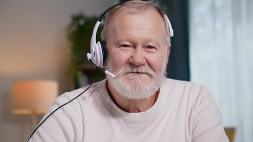 Senior Man Wearing Headset Smiling at Camera