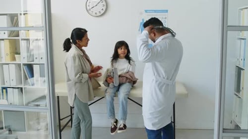 Doctor Examining Young Child in Bright Medical Office