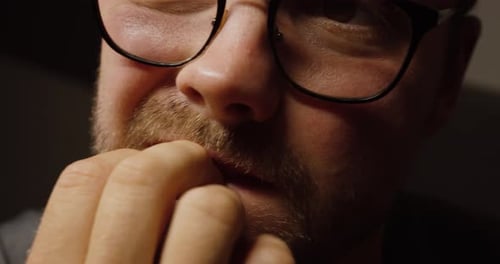 Close-Up of Man Biting Fingernails