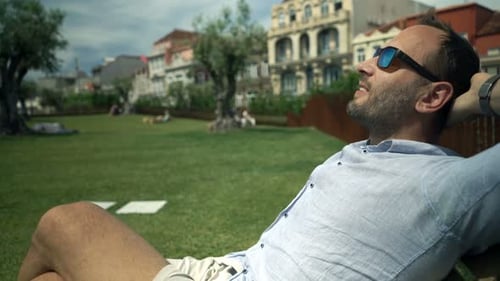 Young Man Relaxing in Park in City 30s