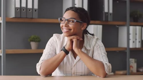 Smiling Woman in Office Looking to Side
