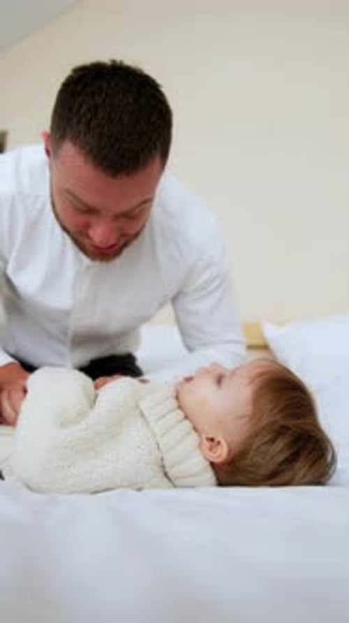 Adult and Child Playful Time on Bed