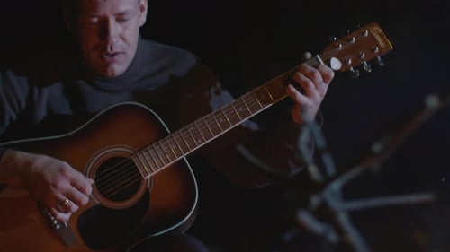 Man Plays Guitar By Campfire at Night