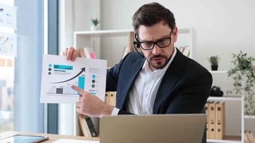 Confident Businessman Presenting Growth Chart in Office Environment