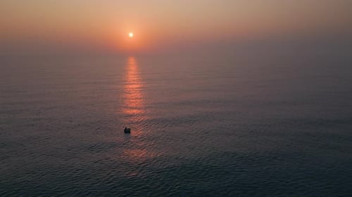 Vietnamese round boat floating in the sea at sunset