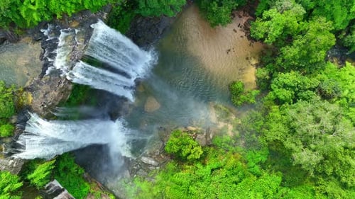 Spectacular waterfall in a tropical forest from above.