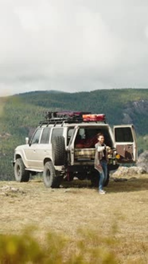 Woman Preparing for Adventure in Rural Mountain Setting