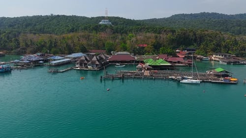 Two Guys Paddling in a Kayak Among the Houseboats of Log Chang Island
