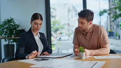 Business Partners Planning Investment Sitting Office Desk with Papers Closeup