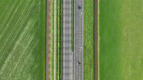Drone view of a road in the middle of a field. Landscape from a drone. Road and transport.