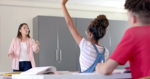 Young biracial woman teaches in a high school classroom