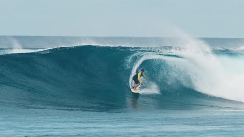 Professional Surfer Rides Big Ocean Wave in the Maldives