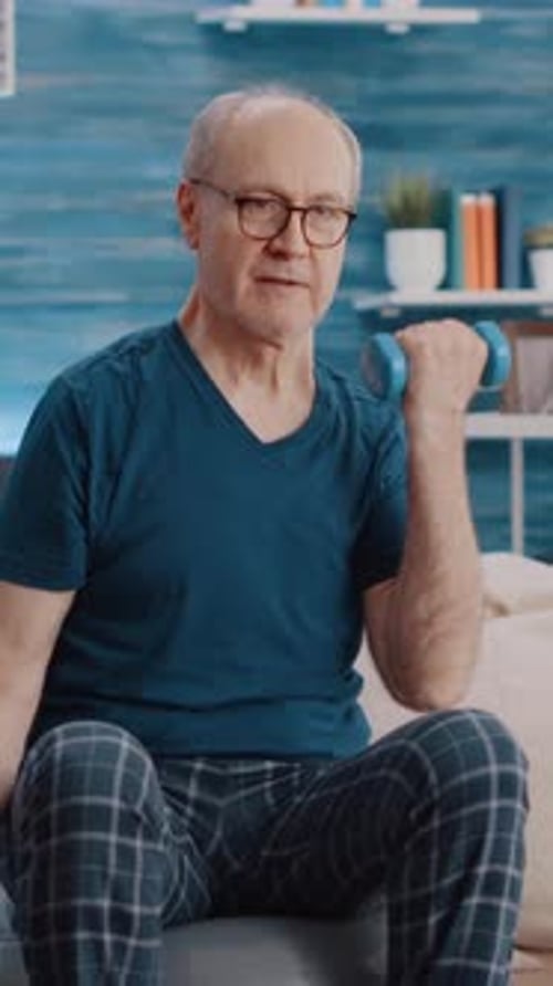 Senior Man Working Out With Weights at Home