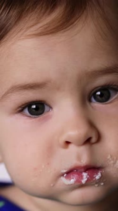 Adorable Infant with Food Smudged on Face