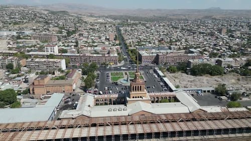 Cityscape skyline aerial pulls back from Yerevan Rail Station, Armenia