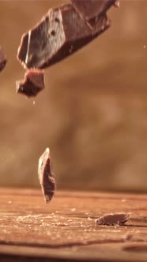 Pieces of Chocolate Fall on a Wooden Table Filmed on a Highspeed Camera at 1000 Fps