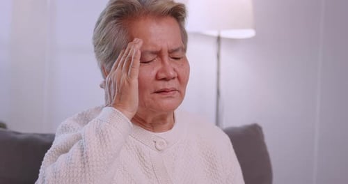 Senior Woman with Headache Indoors