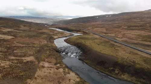 Aerial footage of a fast moving river hitting hard on every rock it passes by. Filmed in the Islandi