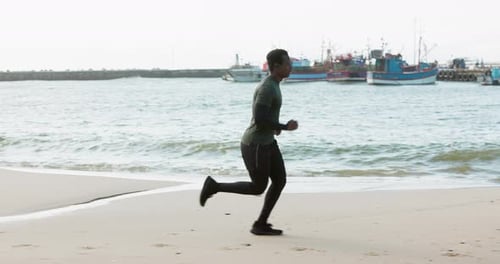 Running, fitness and man on beach for exercise, marathon training and cardio workout outdoors