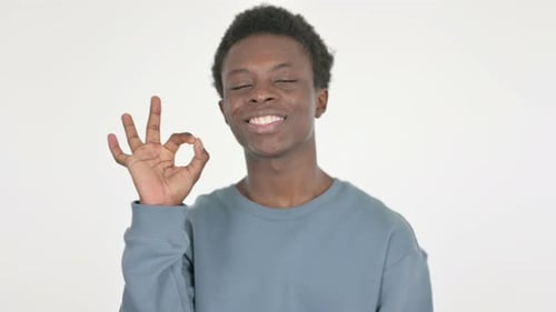 Young Adult Smiling and Giving OK Hand Gesture