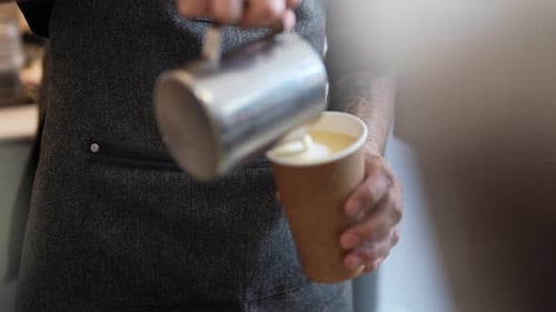 Latte Art Pouring into Paper Coffee Cup
