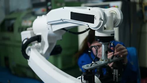 Female Robotics engineer working with Programming and Manipulating Robot Hand