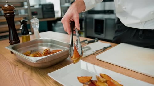 Chef plating delicious looking potato wedges