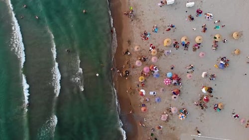 colorful umbrellas on the beach and drone view of the sea