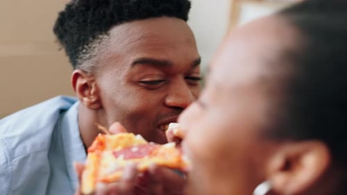 Young Couple Eating Pizza in New Home
