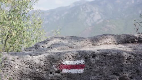 Hiking trail, trail sign. Hikers foots on stone with trail sign.