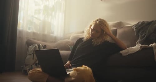 Young Woman Works on Laptop Indoors