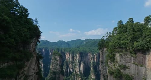 Aerial tilt shot rising in middle of rocky quartz pillars, in Wulingyuan, Zhangjiajie