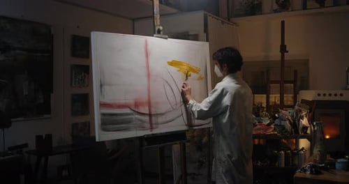 Artist Painting an Abstract on Canvas in Studio