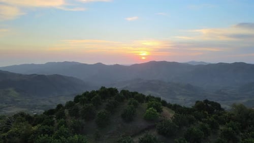 rotate aerial drone view of hills with sunrise background. landscape on the slopes of the mountain a