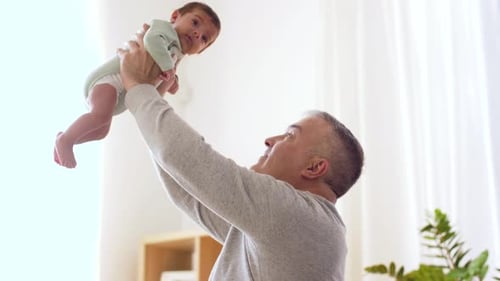 Family, Parenthood And People Concept - Happy Father With Little Baby Boy At Home