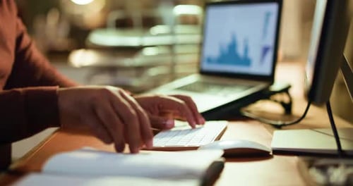 Hands, computer and businessman writing in notebook for trading details, price targets or deadline