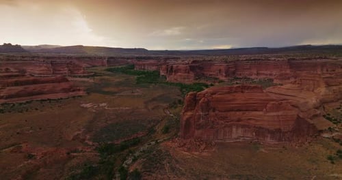 Scenic view of canyons in Utah, USA. Cloudy grey skies over the rocks and plains