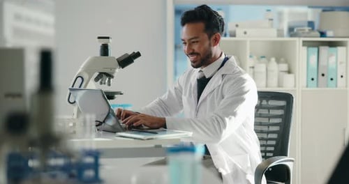 Scientist Working on Laptop in Bright Lab