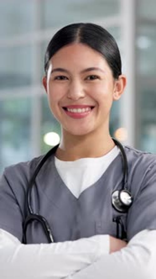 Nurse, happy and face of woman in hospital with crossed arms for medical service, career and job