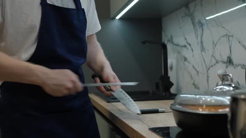 Chef Sharpening Knife with Steel in Modern Kitchen
