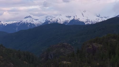 Scenic View of Snow-Capped Mountains and Lush Green Forests in BC