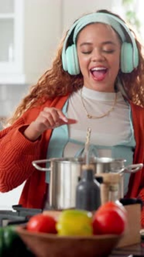 Woman Cooking and Dancing at Home with Headphones