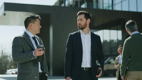 Smiling Attractive Two Business Men Walking Talking Discussing on Street in Modern City Near