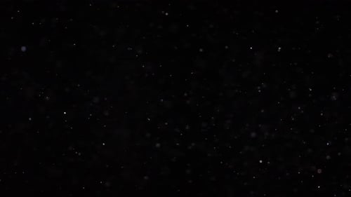 Abstract Particles Floating on Black Background