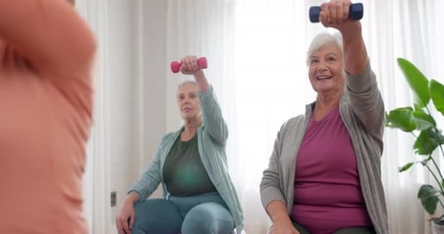 Senior Women Exercising with Weights in Home