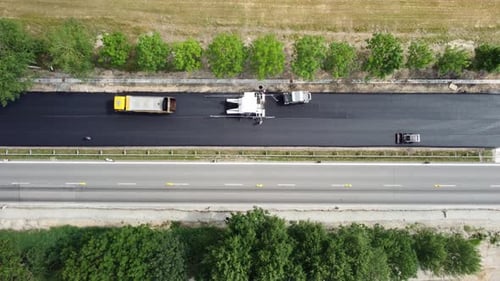 Asphalt paver at work, aerial view.