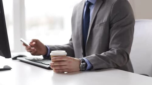 People, Business, Technology And Office Work Concept - Closeup Of Businessman With Smartphone Dri...