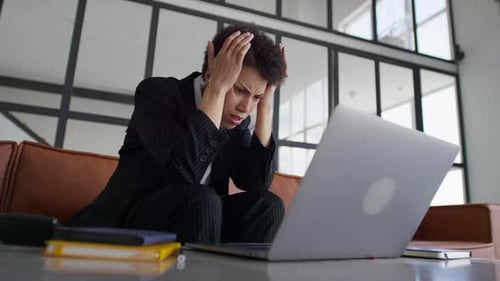 Desperate Businesswoman Stressed at Laptop