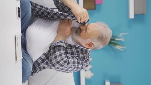 Vertical video of The sweating old man smells bad and offensive.