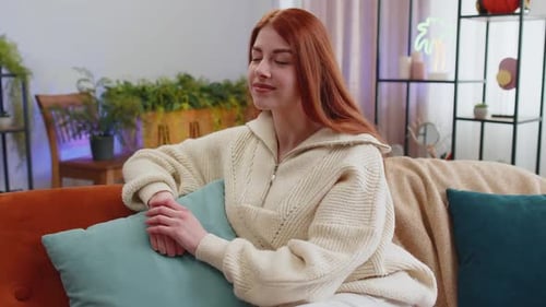 Smiling Woman Relaxing on Couch in Home Interior